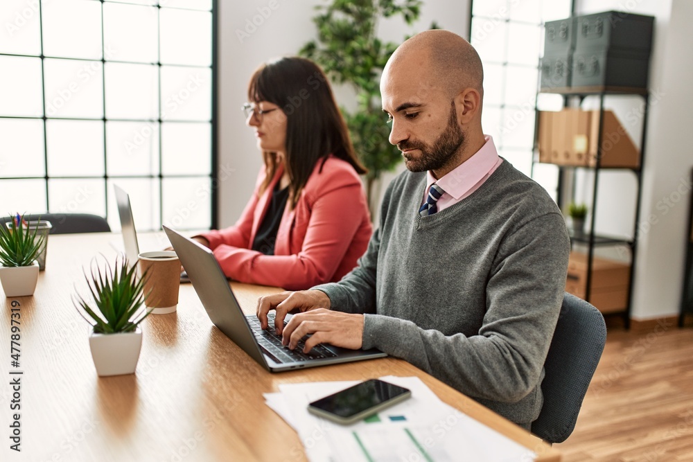 Two hispanic business workers with serious expressios working at the office. Two hispanic business workers with serious expressios working at the office.