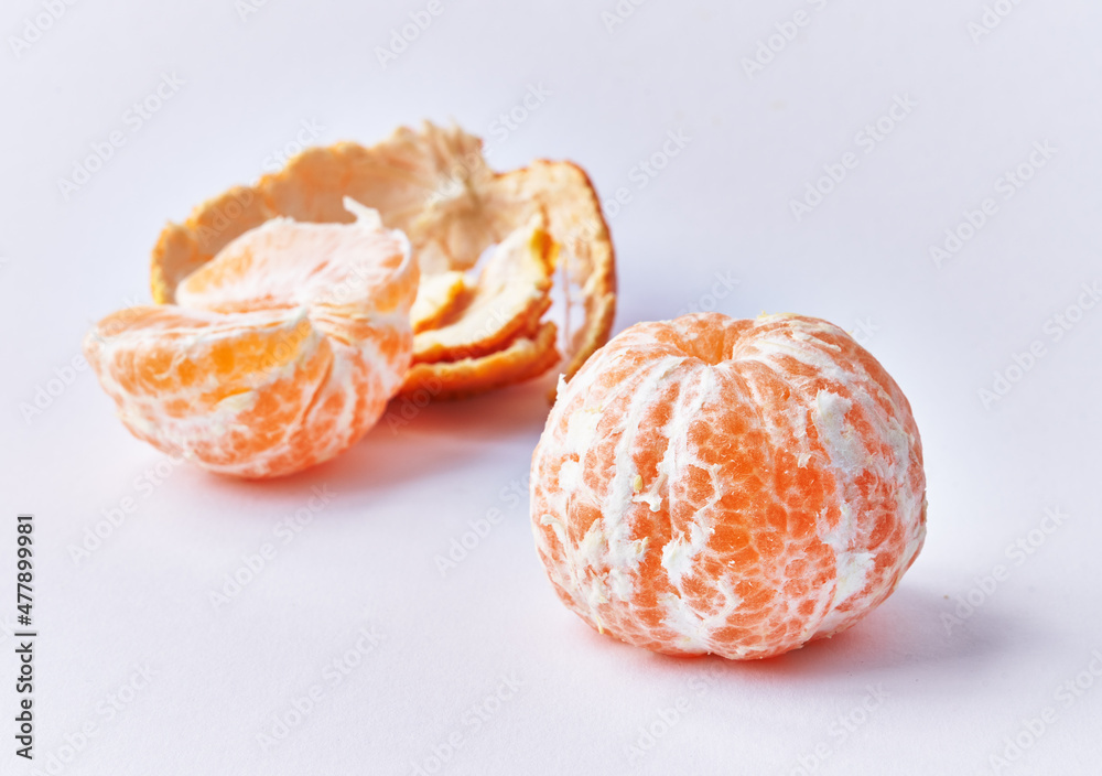  Two peeled tangerines isolated over white background