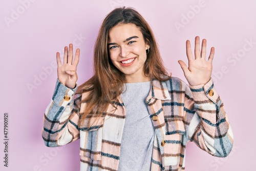Young caucasian girl wearing casual clothes showing and pointing up with fingers number nine while smiling confident and happy.