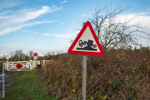 Close and selective focus on an uneven road sign located near a railway gate in the village of Reedham, Norfolk photo