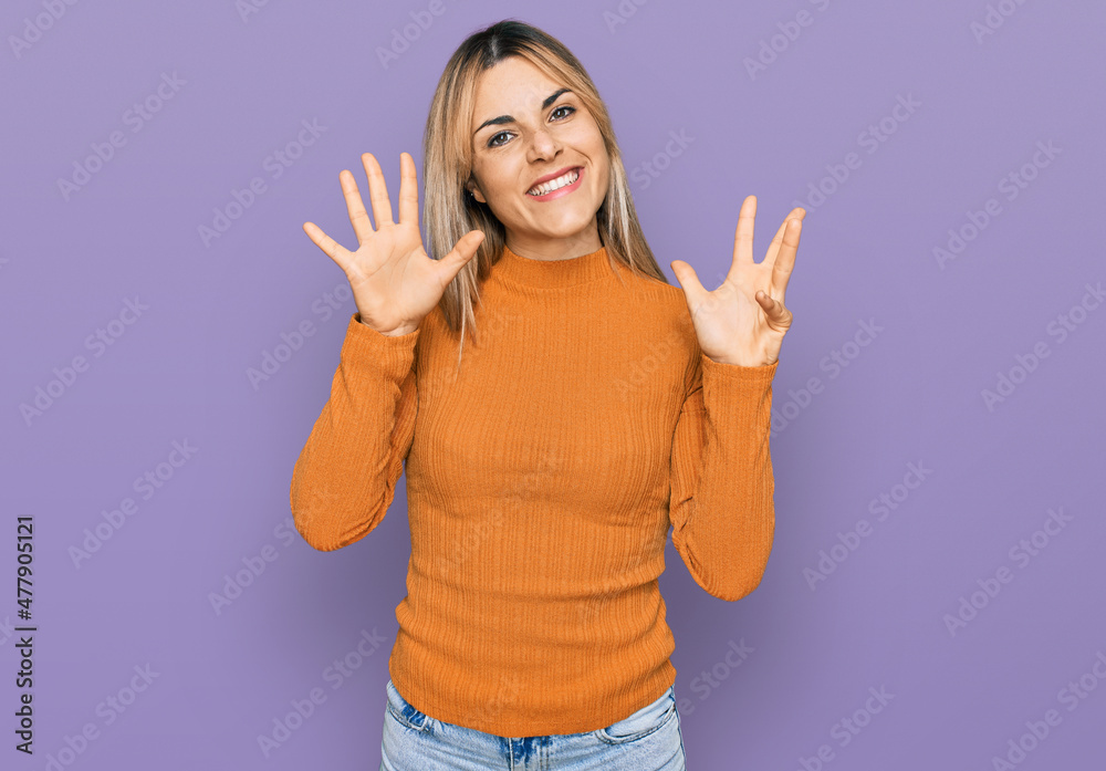 Young caucasian woman wearing casual clothes showing and pointing up with fingers number nine while smiling confident and happy. Young caucasian woman wearing casual clothes showing and pointing up with fingers number nine while smiling confident and happy.