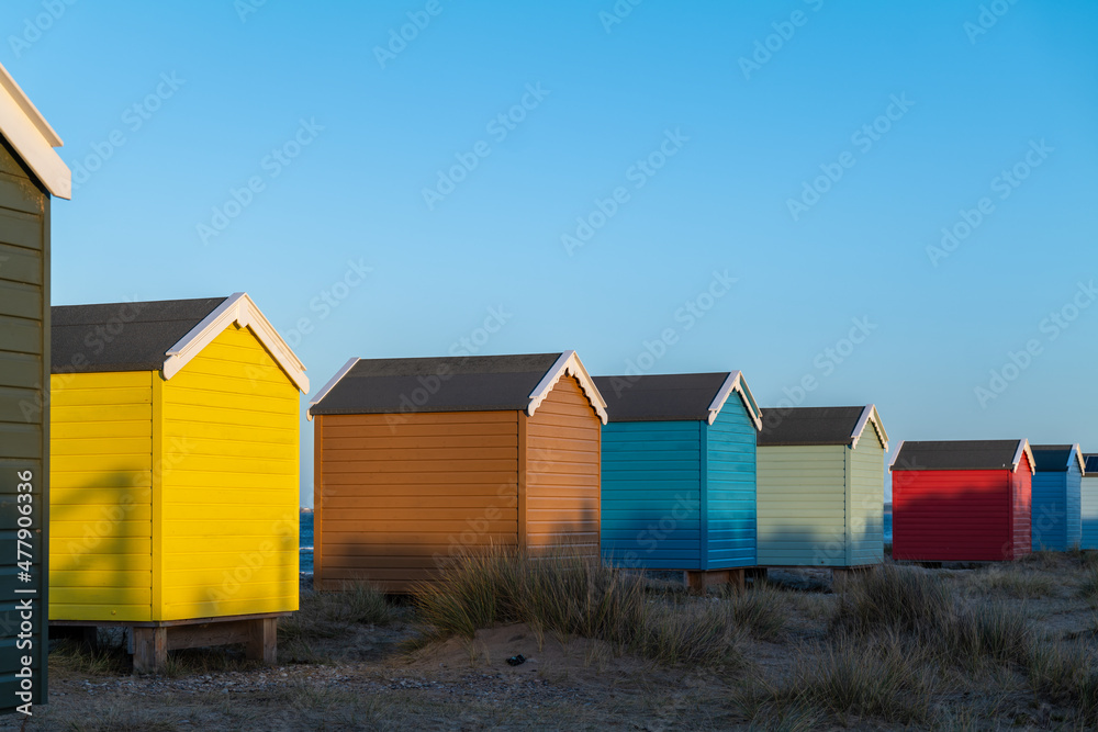FINDHORN, MORAY, SCOTLAND - 1 JANUARY 2022: This is the beach huts getting the last of the sun at Findhorn, Moray, Scotland. FINDHORN, MORAY, SCOTLAND - 1 JANUARY 2022: This is the beach huts getting the last of the sun at Findhorn, Moray, Scotland.
