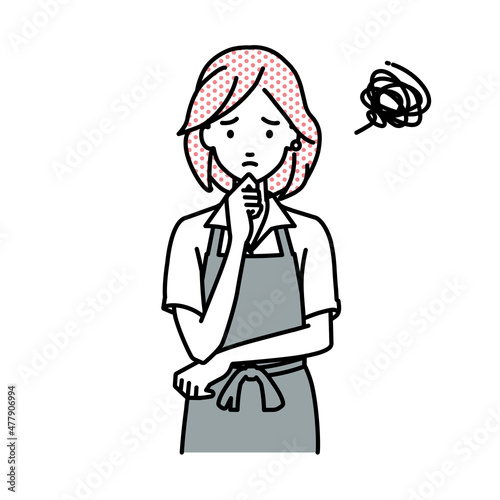 立って手をあごにあてて困っているカフェ店員の女性
