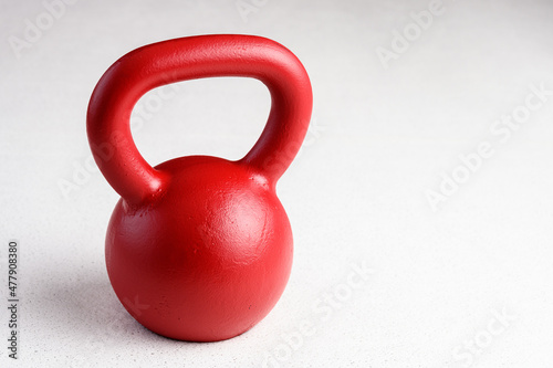 Kettlebell winter fitness, red kettlebell on a white background with silver sparkles
