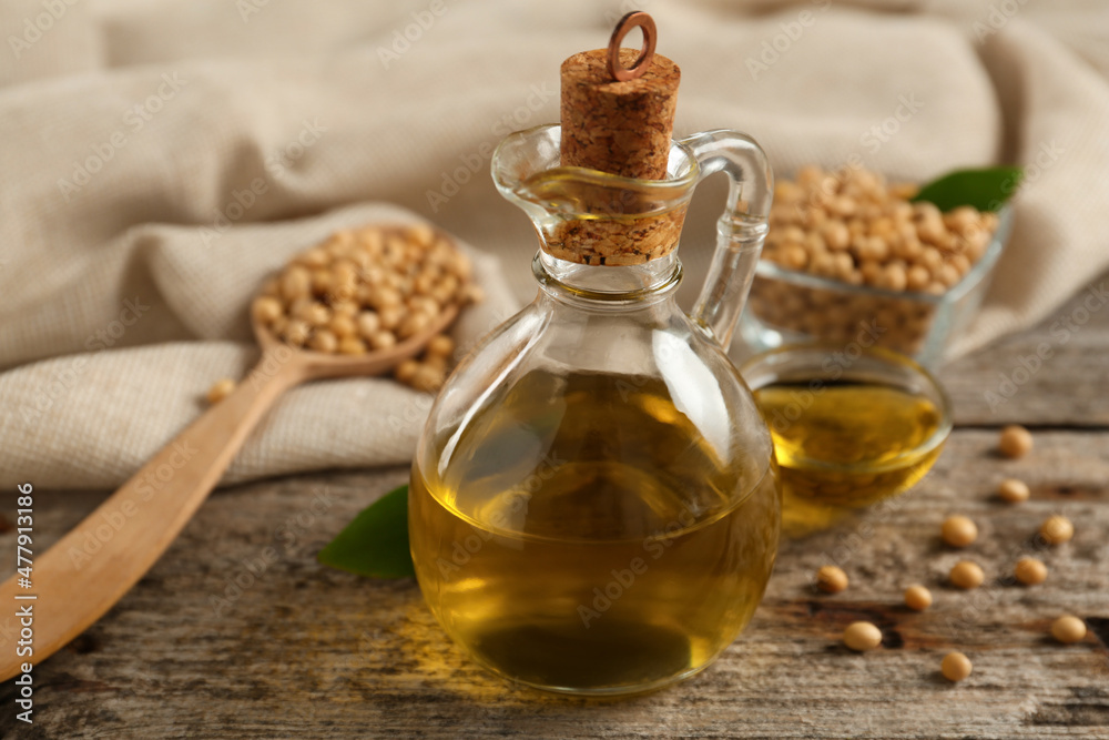 Composition with soybean oil on wooden table Composition with soybean oil on wooden table