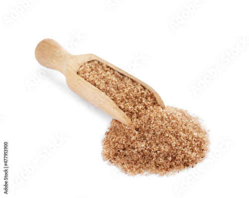 Wooden scoop with brown salt on white background