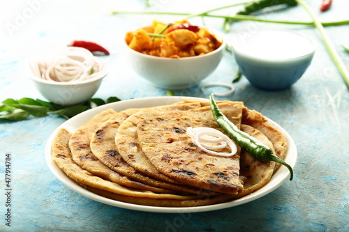 Aloo paratha - poato masala stuffed Indian flat bread served with fresh raita. photo