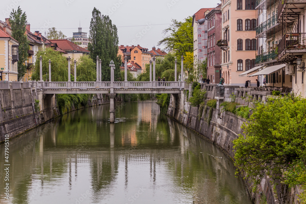 LJUBLJANA, SLOVENIA - MAY 14, 2019: Riverside buildings and the Cobblers bridge in Ljubljana, Slovenia