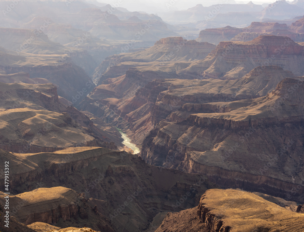 Colorado River Flows Through The Middle Of The Hazy Grand Canyon