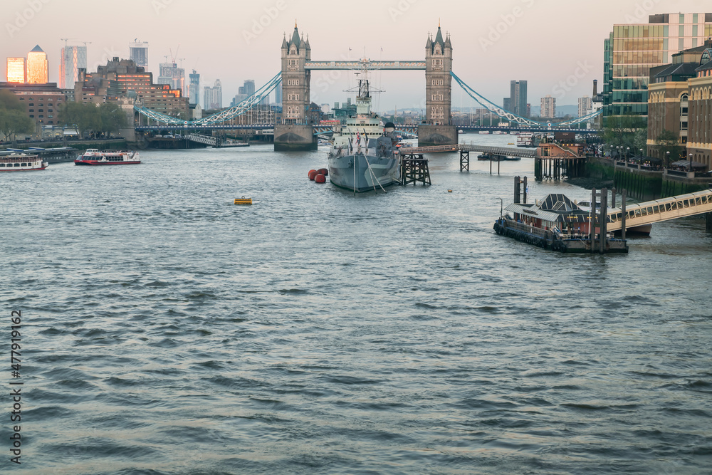 London, England - Apr 20, 2019 : HMS Belfast is a Town-class light cruiser that was built for the Royal Navy. She is now permanently moored as a museum ship in front of Tower Bridge on the River Thame