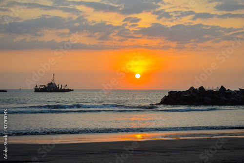 Fishing boat anchored during sunset 