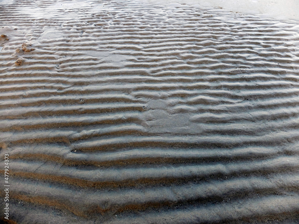 waves on sand. Texture of sand.