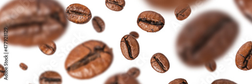 Billede på lærred Brown roasted coffee beans flying on a white background.
