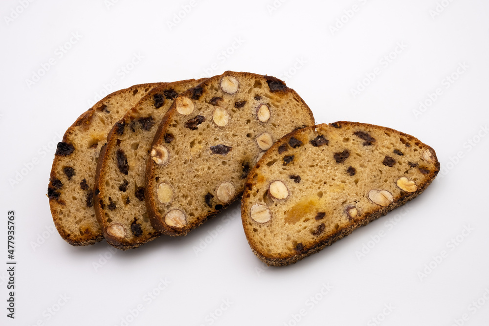 Slices of sweet dessert multigrain bread with nuts and raisins. Healthy diet. Isolated on white background. Slices of sweet dessert multigrain bread with nuts and raisins. Healthy diet. Isolated on white background.