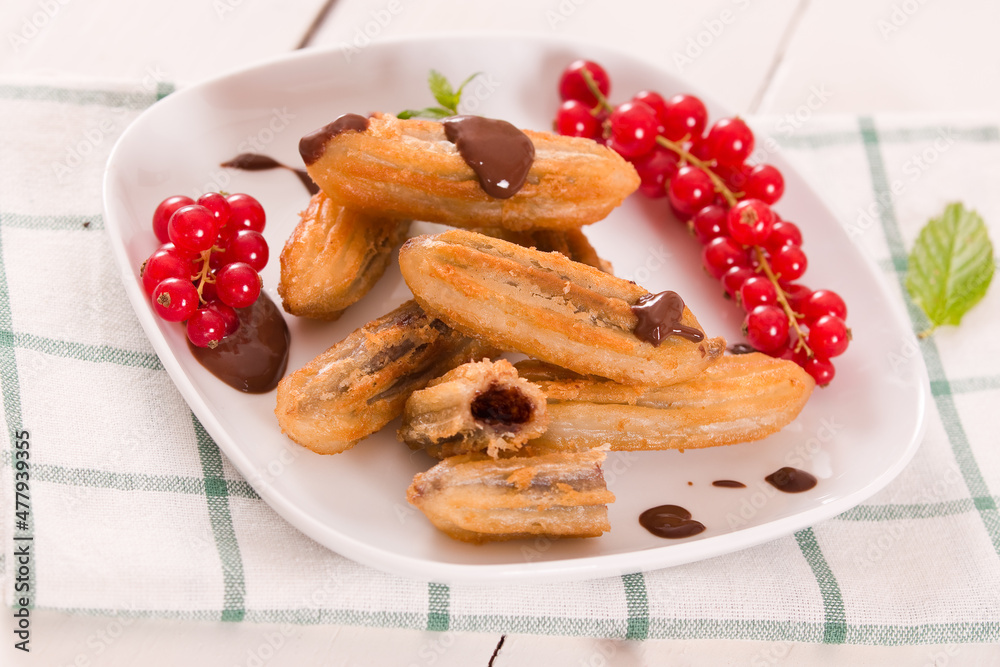 Mini churros with chocolate dipping sauce. Mini churros with chocolate dipping sauce.