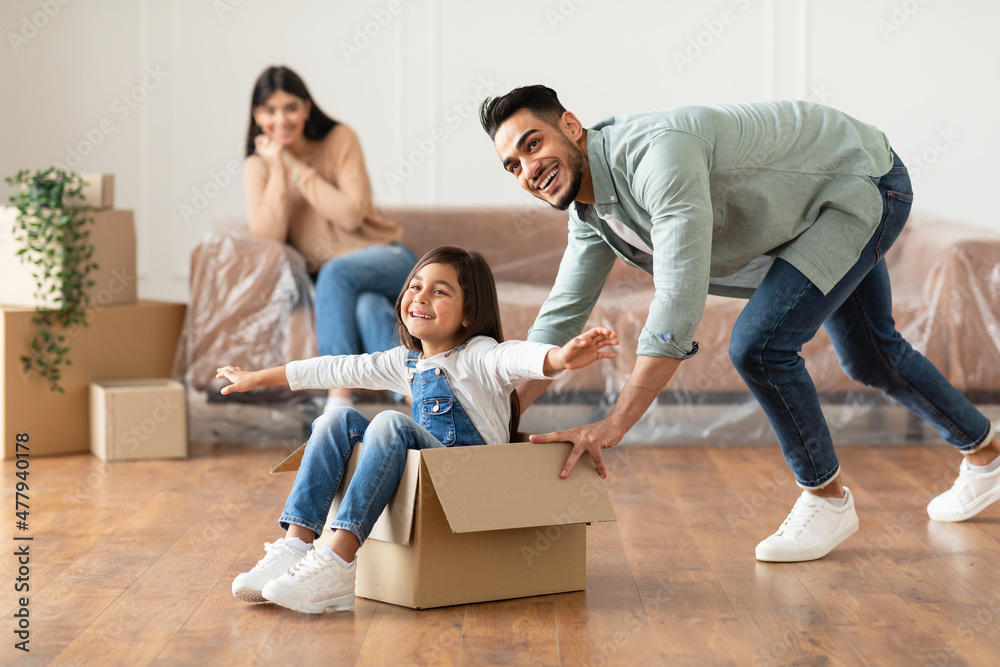 Happy family celebrating moving day in new apartment Happy family celebrating moving day in new apartment