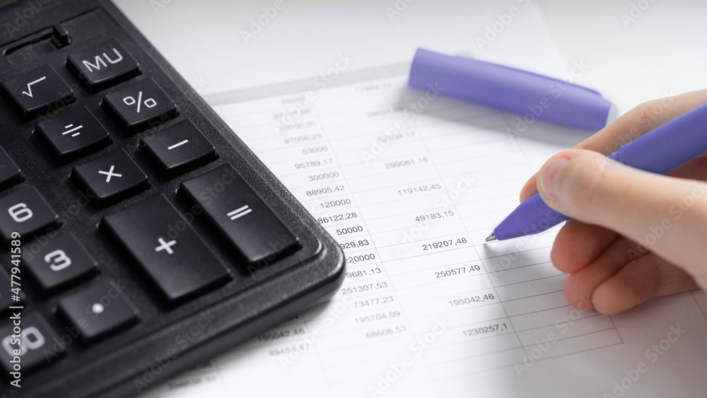 Calculator and pen on white paper with numbers. Business and finance accounting concept. Calculator and pen on white paper with numbers. Business and finance accounting concept.