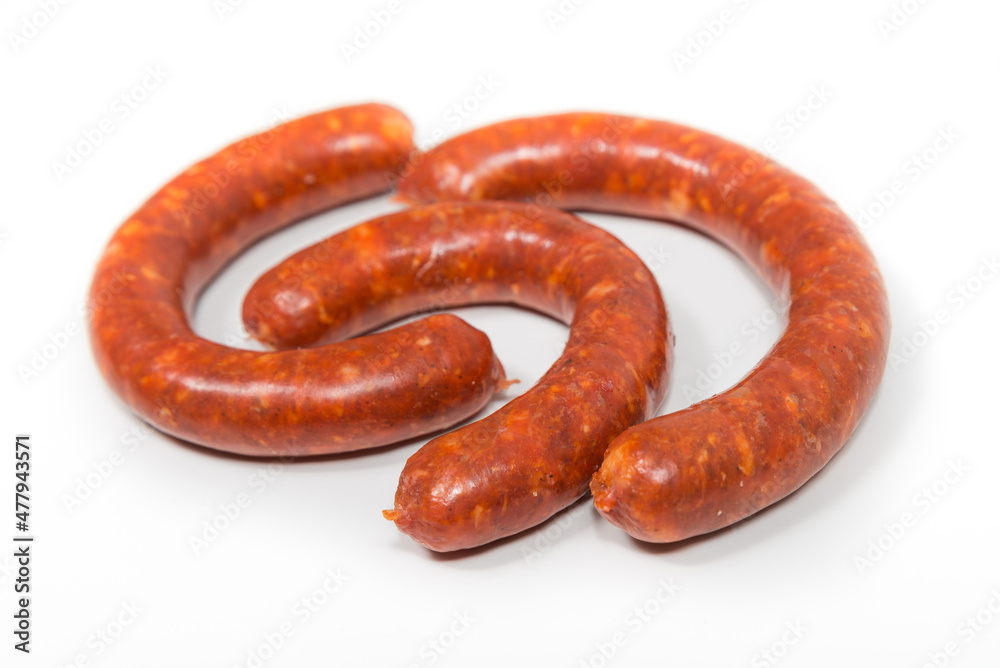 Three red chorizo crude sausages on a white background Three red chorizo crude sausages on a white background