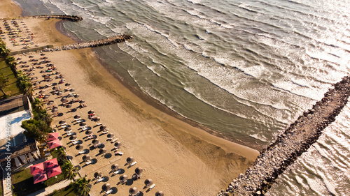 View to sandy beach of Adriatic Sea and to the city of Durres, Albania during sunset. photo