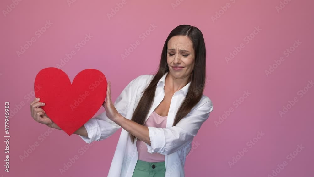 Upset lady not like heart boyfriend throw isolated pastel color background Upset lady not like heart boyfriend throw isolated pastel color background