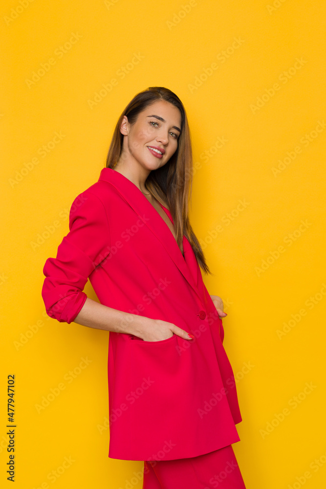 Cool young woman is posing in oversize red suit Cool young woman is posing in oversize red suit