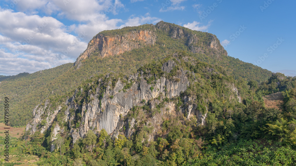 Scenic landscape view of karst limestone mountain with cliff and tropical forest in beautiful rural valley, Chiang Dao, Chiang Mai, Thailand
