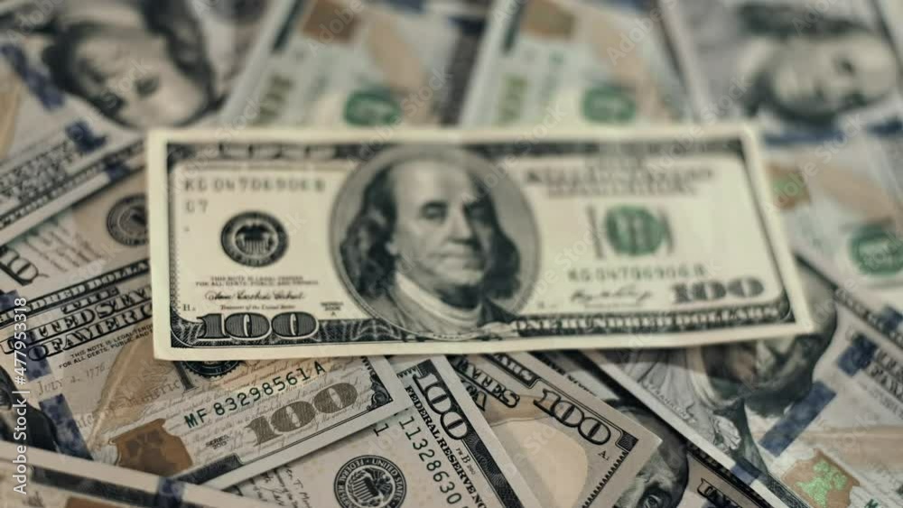 One hundred US dollars. Backward direction close up dolly shot of scattered American paper money bills with a variety of denominations.
Blurred background. One hundred US dollars. Backward direction close up dolly shot of scattered American paper money bills with a variety of denominations.
Blurred background.