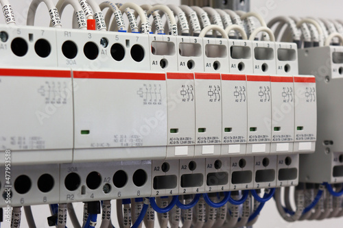 4-pole and 2-pole electromagnetic contactors with connected mounting wires located in the electrical panel