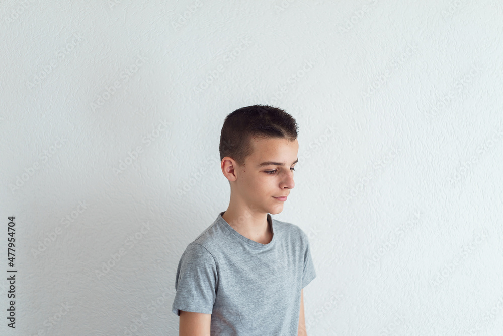 Photo of adorable young sad boy looking at floor.Isolated on the white background Photo of adorable young sad boy looking at floor.Isolated on the white background