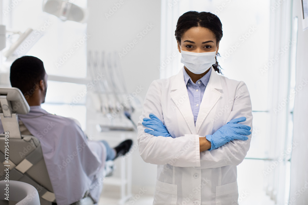 Portrait Of Young Black Female Stomatologist In Medical Mask Posing At Workplace Portrait Of Young Black Female Stomatologist In Medical Mask Posing At Workplace