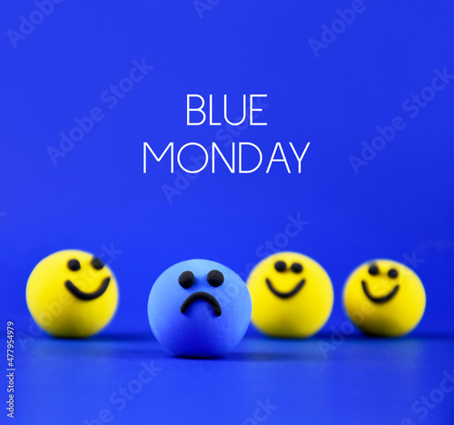 Blue Monday stock images. The most depressing day of the year. Sad day in january images. Blue sad ball and happy yellow balls stock images. Single sad blue smiley among happy yellow ones stock photo