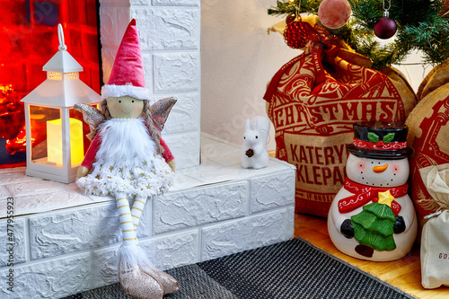 Christmas doll near the fireplace