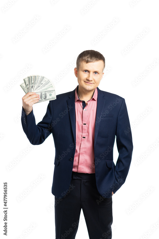 business man in a suit. a young man holds dollars and rejoices. the man laughs cheerfully, he is pleased with his earnings. businessman got holding a lot of money. isolated business man in a suit. a young man holds dollars and rejoices. the man laughs cheerfully, he is pleased with his earnings. businessman got holding a lot of money. isolated
