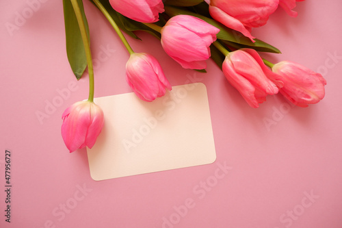 Pink fresh tulip flower composition with blank letter paper. Valentine, Mother's day, Women's day and spring time concept flower background.