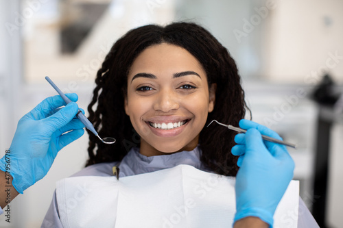 Portrait Of Smiling African American Lady Getting Teeth Treatment At Dental Clinic