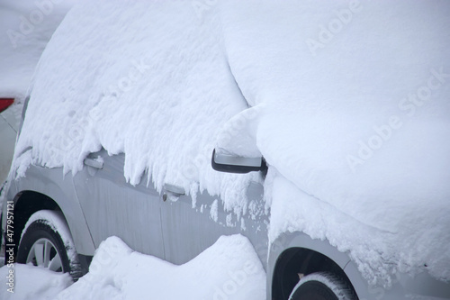 A car under the snow. Heavy snowfall.