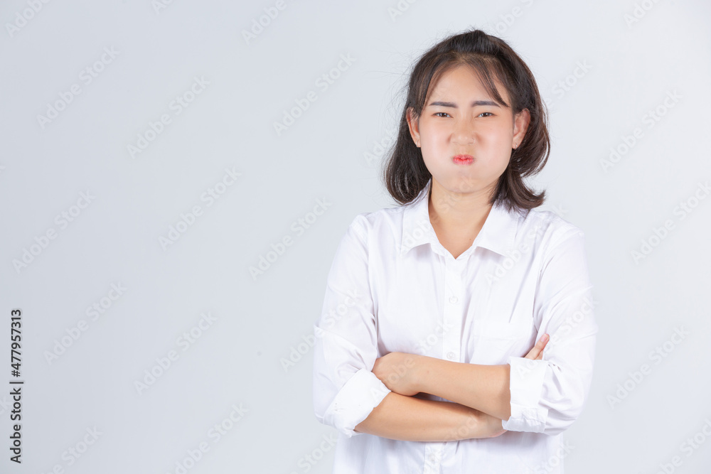 A young woman smiling cheerfully on a white background. A young woman smiling cheerfully on a white background.