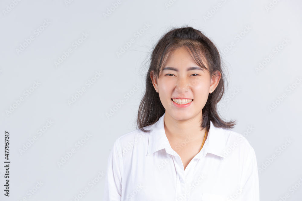 A young woman smiling cheerfully on a white background. A young woman smiling cheerfully on a white background.