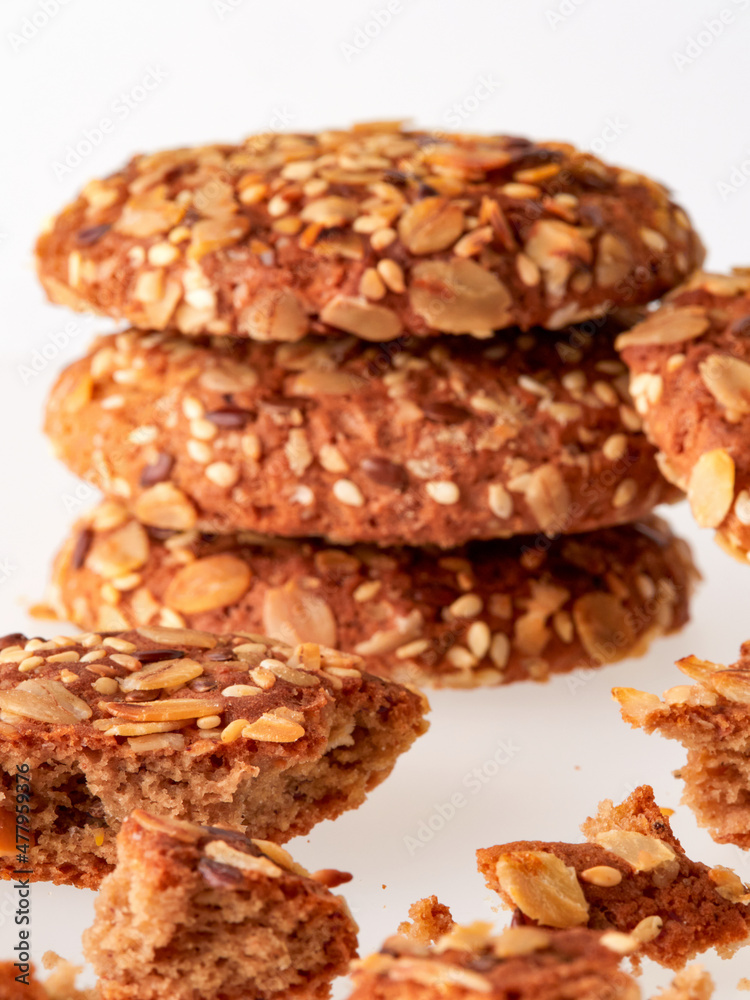 Oatmeal cookie with crumbs isolated on white background. Top view.