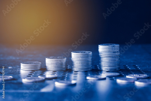 stacks of money coin with blue filter. Business and financial investment concept. 