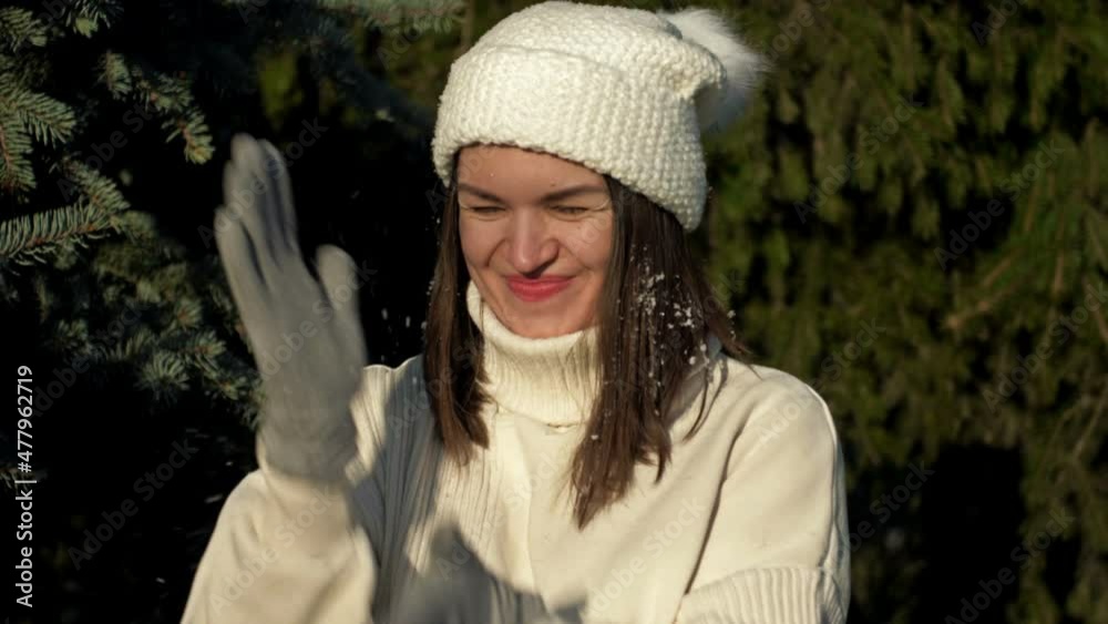 Young cheerful woman in light clothes rejoices in the first snow and plays in the forest. Young cheerful woman in light clothes rejoices in the first snow and plays in the forest.