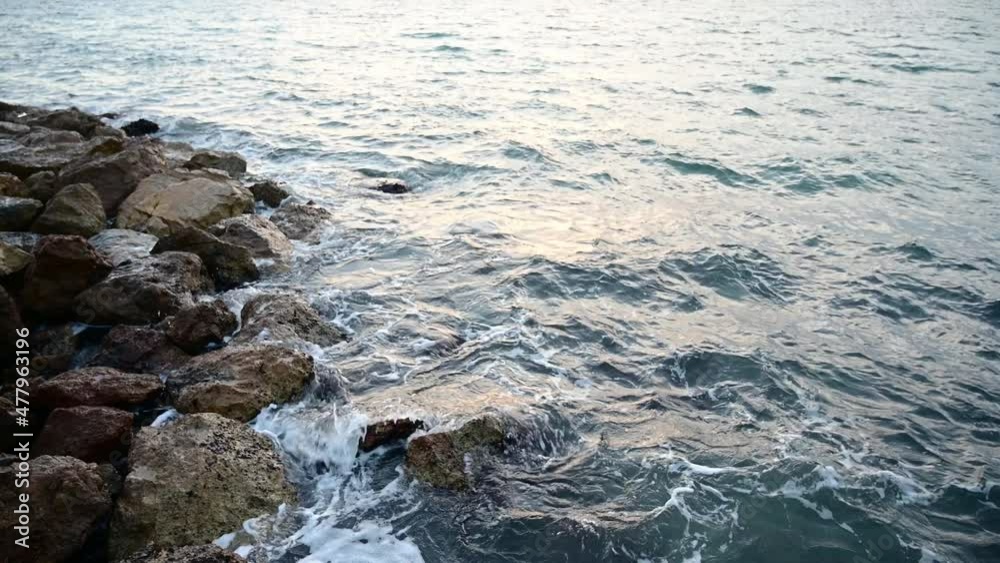 Video of sea waves breaking on the rocky shore at the beach of Salou, Tarragona Video of sea waves breaking on the rocky shore at the beach of Salou, Tarragona