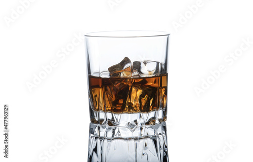 A glass with whiskey and ice isolated on a white background.