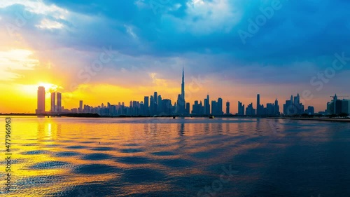 Dubai city skyline day to night transition timelapse with towers and modern buildings panoramic view. 4k Time lapse video shot on a cloudy day with moving clouds Dubai, United Arab Emirates