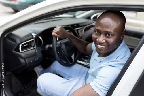 Ecstatic black guy getting in brand new car