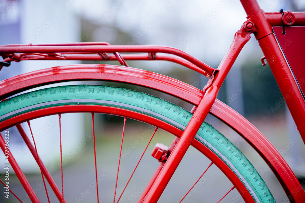 rear section of red painted bicycle with green tires rear section of red painted bicycle with green tires
