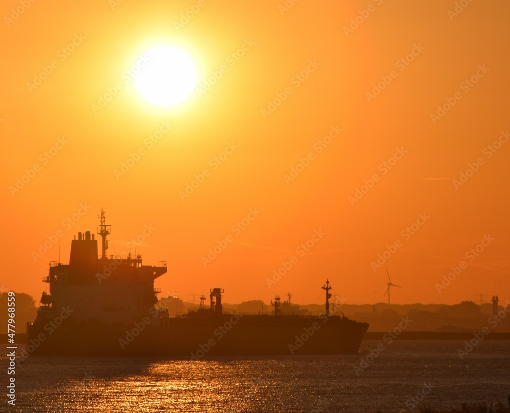 Bright sunset over ships at sea