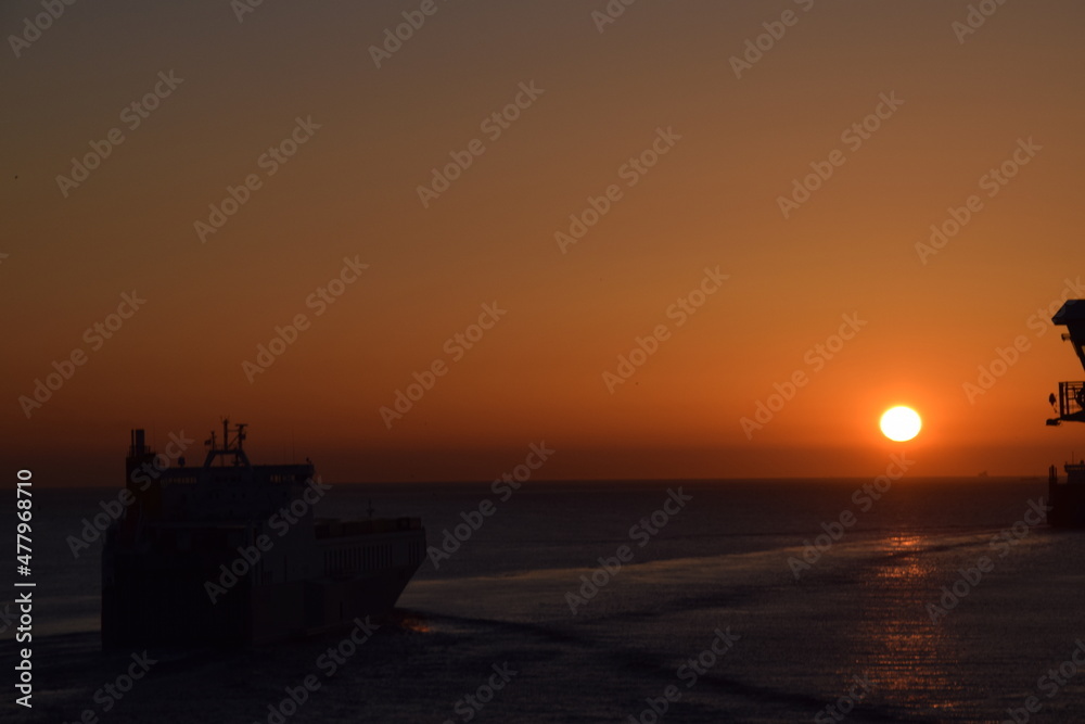 Bright sunset over ships at sea