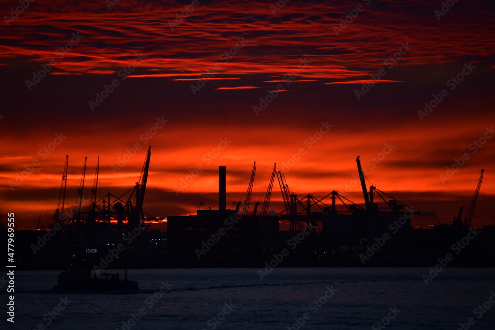 Deep red sky over silhouetted cityscape