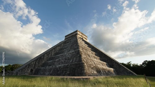 Wallpaper Mural Timelapse of the temple of Kukulcan (El Castillo) on the green loan, the center of the archeological site in Chichen Itza, a city built by the Maya people. Clouds float above the temple. No tourists Torontodigital.ca